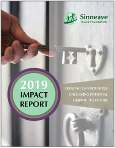 Image of a hand holding a key and key hole on cover of Sinneave Family Foundation 2019 Impact Report with the words Creating Opportunities, Unlocking Potential, Shaping the Future