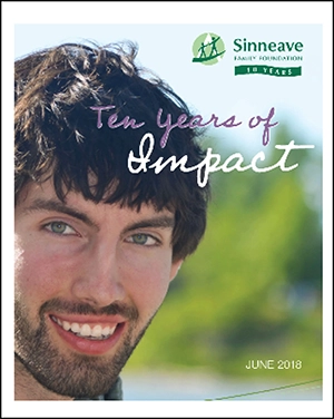 On a graphic background, is the logo of The Sinneave Family Foundation in green and white. Below it, the text reads, "Ten years of Impact". This is the cover image of the 2018 Ten years of Impact Report.